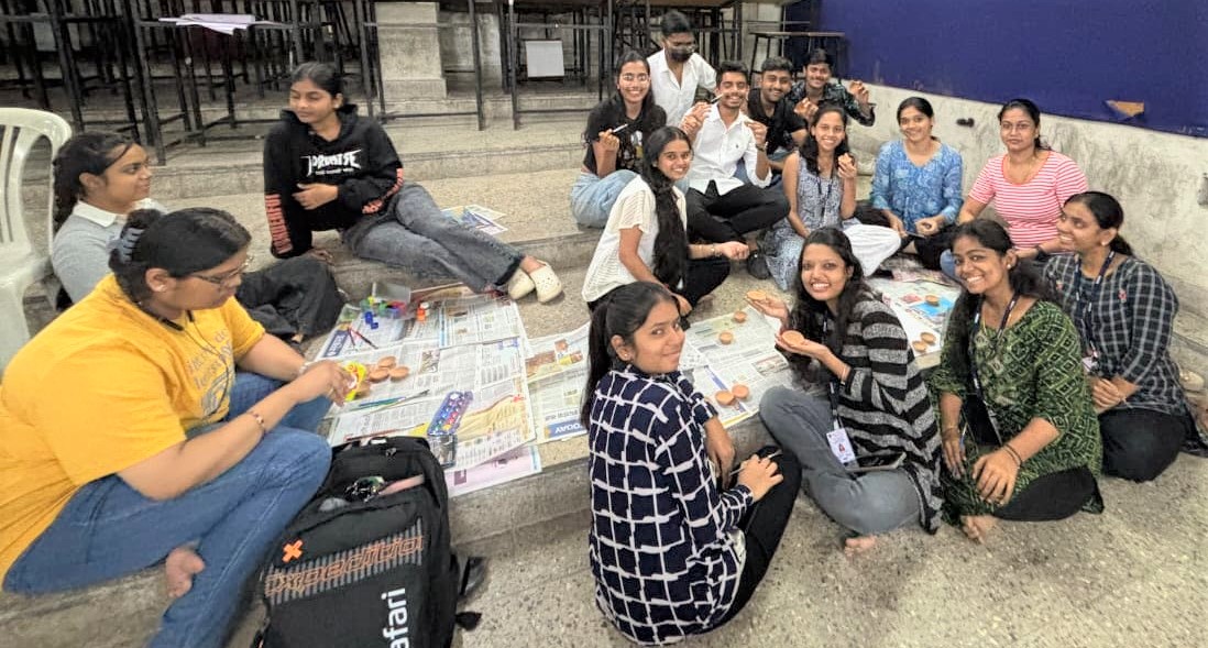 Students displaying diya painting work