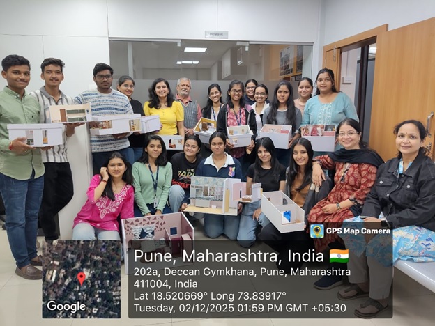 Students participating in a model making workshop